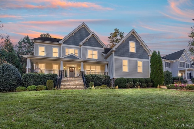 craftsman house with a porch and a front lawn