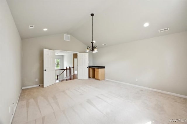 unfurnished living room with visible vents, light colored carpet, vaulted ceiling, and an inviting chandelier