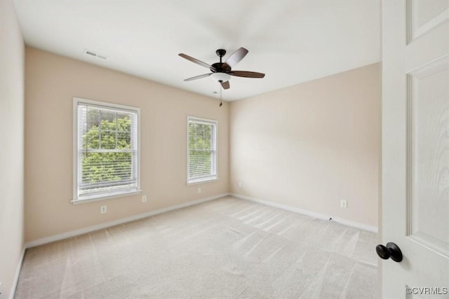 unfurnished room featuring baseboards, ceiling fan, visible vents, and light colored carpet