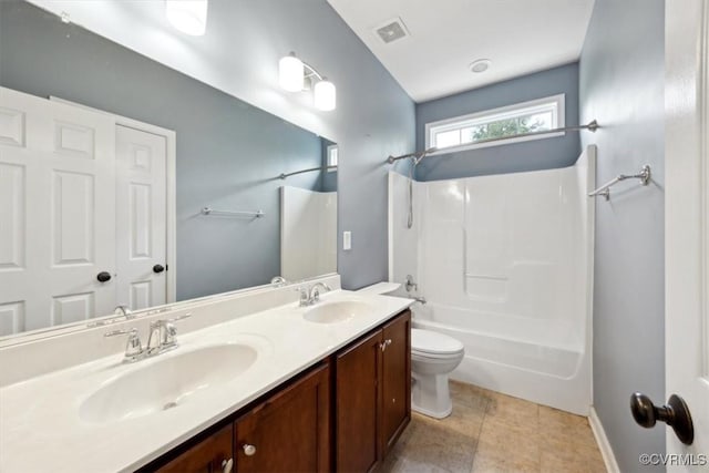 full bath featuring a sink, toilet, shower / bath combination, and double vanity