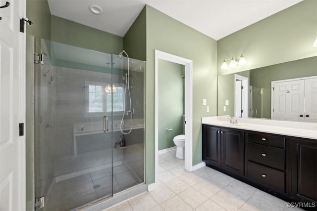 bathroom featuring toilet, tile patterned floors, a shower stall, and vanity