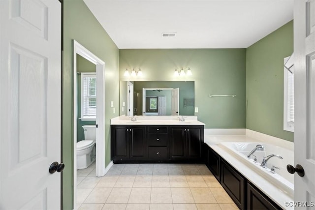 full bathroom featuring visible vents, double vanity, toilet, tile patterned floors, and a sink