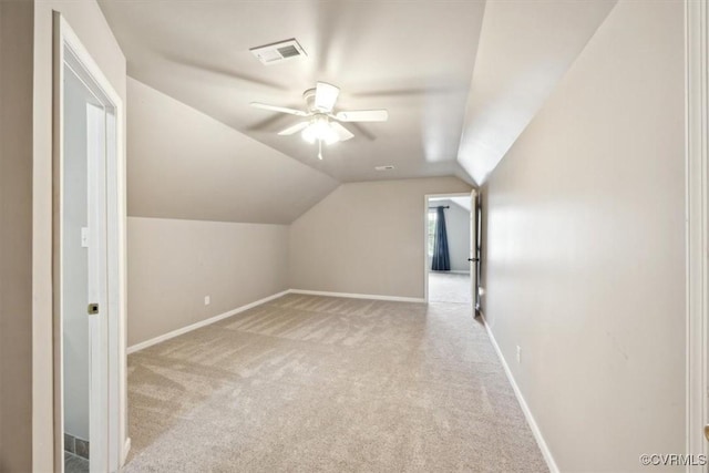 bonus room with carpet floors, visible vents, baseboards, a ceiling fan, and vaulted ceiling