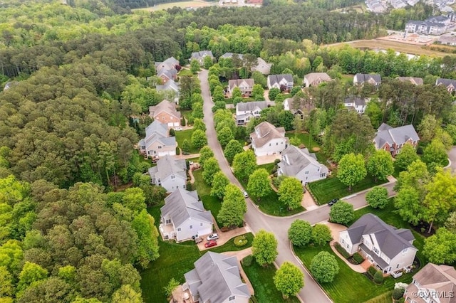 birds eye view of property featuring a residential view and a view of trees