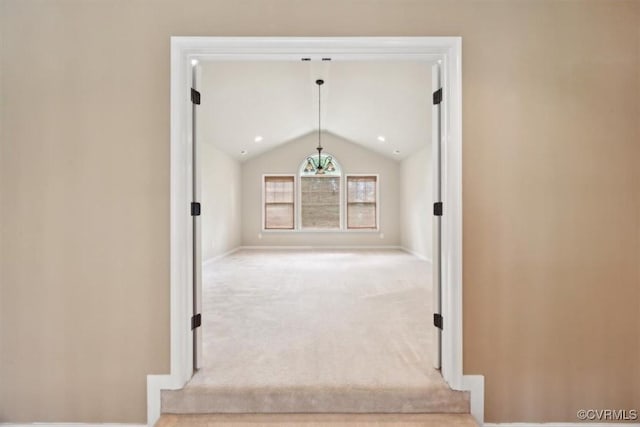 interior space featuring baseboards, vaulted ceiling, and carpet flooring