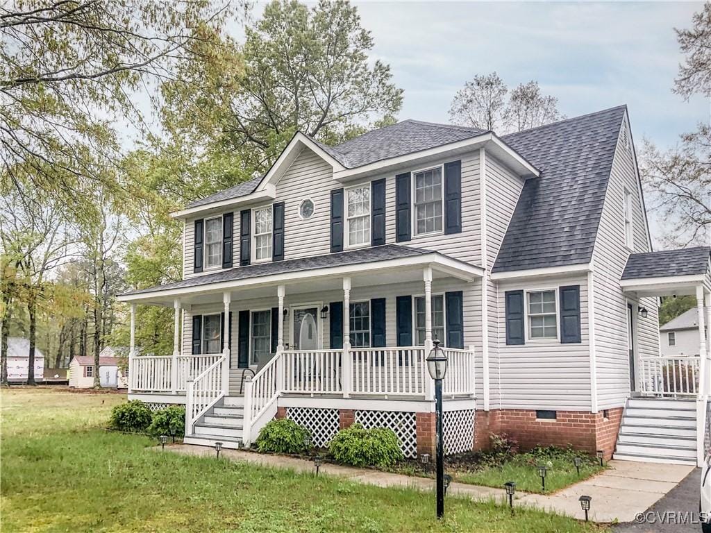 colonial inspired home featuring a front lawn, covered porch, crawl space, and roof with shingles