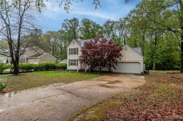 view of front of house with entry steps, a front yard, an attached garage, and concrete driveway