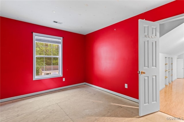 unfurnished room with visible vents and baseboards