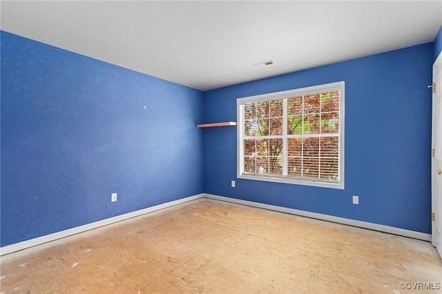 spare room featuring visible vents and baseboards