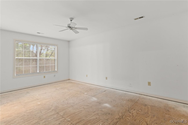 empty room featuring visible vents and a ceiling fan