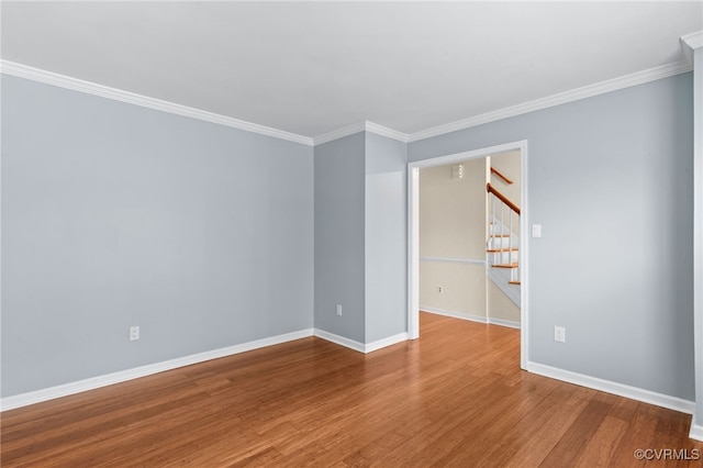 unfurnished bedroom featuring baseboards, ornamental molding, and wood finished floors