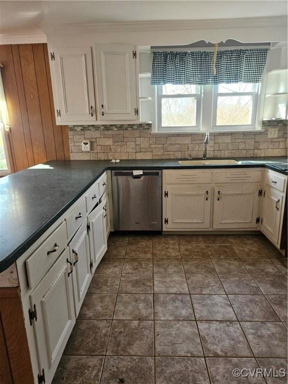 kitchen featuring white cabinets, dishwasher, a sink, dark countertops, and decorative backsplash