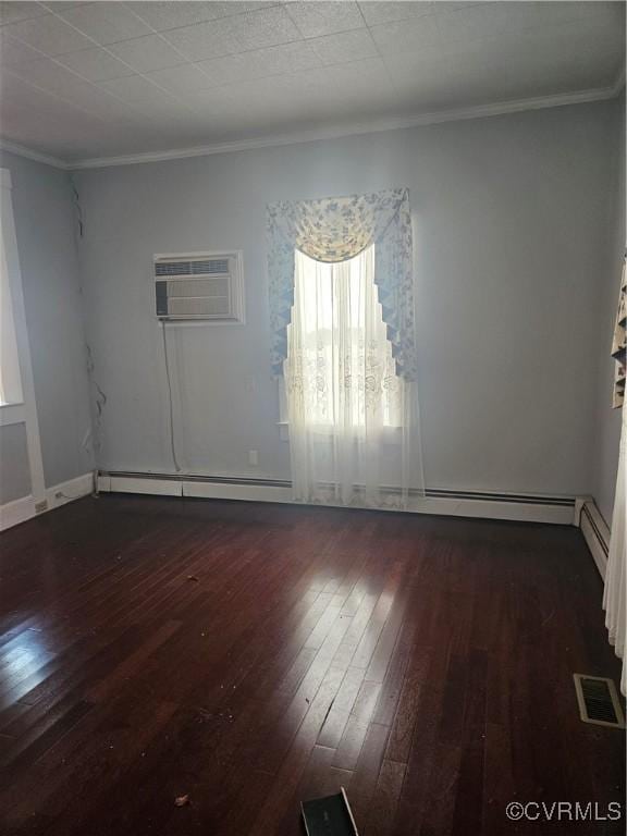 unfurnished room featuring visible vents, hardwood / wood-style floors, and crown molding