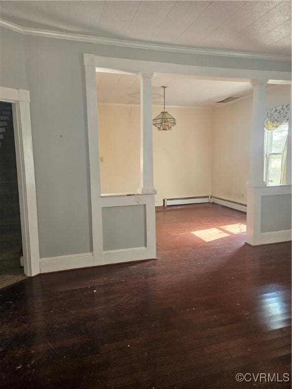 unfurnished room with decorative columns, baseboard heating, ornamental molding, and wood finished floors