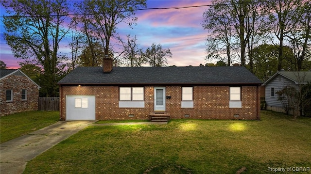ranch-style home with brick siding, driveway, a lawn, and a chimney