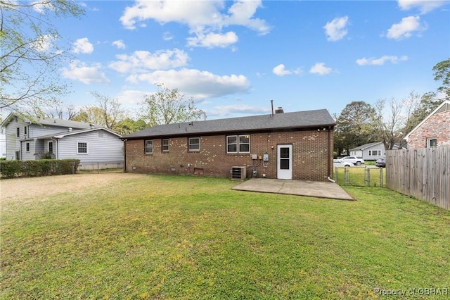 back of property featuring a patio area, brick siding, a fenced backyard, and a lawn