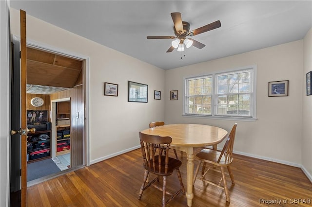 dining room featuring baseboards, ceiling fan, and wood finished floors