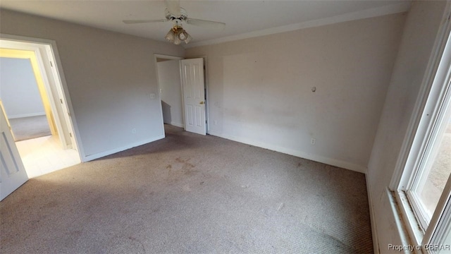 unfurnished bedroom with carpet floors, baseboards, and a ceiling fan