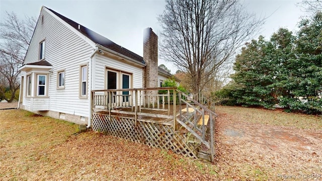 view of property exterior featuring a deck and a chimney
