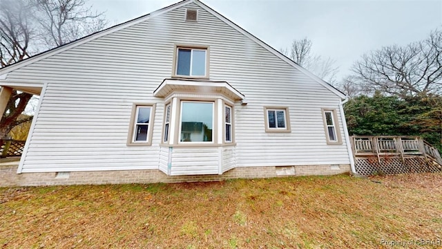 back of house with a yard, a wooden deck, and crawl space
