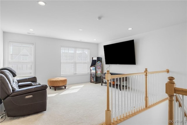 sitting room featuring recessed lighting, an upstairs landing, and carpet floors