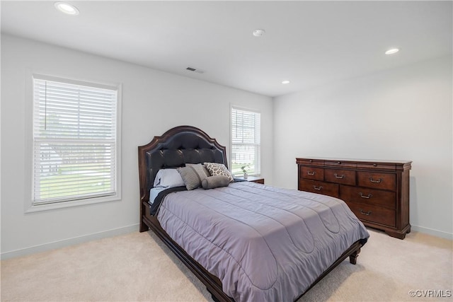 bedroom featuring visible vents, baseboards, recessed lighting, and light carpet