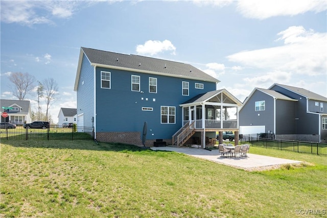 back of property featuring a sunroom, a yard, a fenced backyard, stairway, and a patio