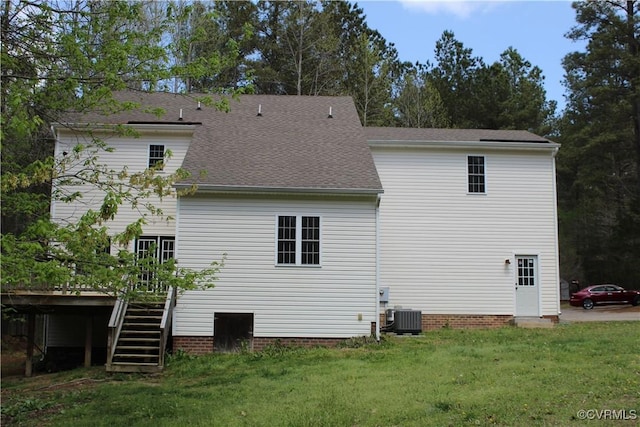 rear view of property with a yard, stairs, a shingled roof, central AC unit, and a deck