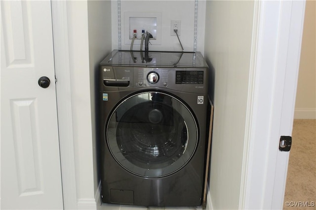 washroom featuring baseboards, carpet flooring, washer / dryer, and laundry area