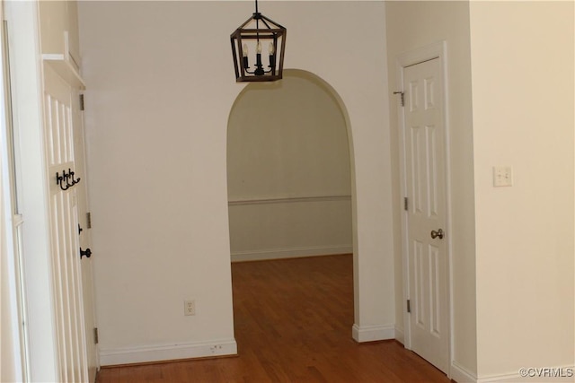 hallway with wood finished floors and baseboards