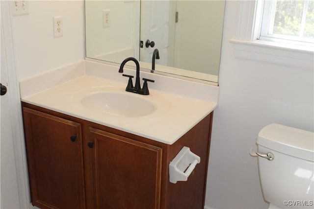 half bathroom featuring toilet and vanity