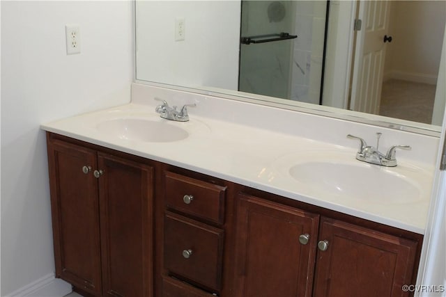 bathroom with a sink, double vanity, and baseboards