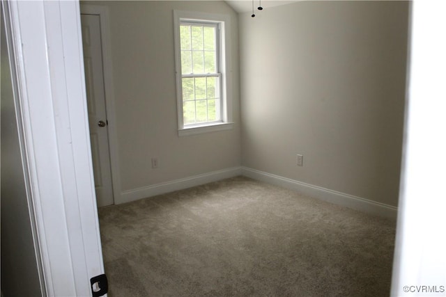 carpeted empty room with baseboards