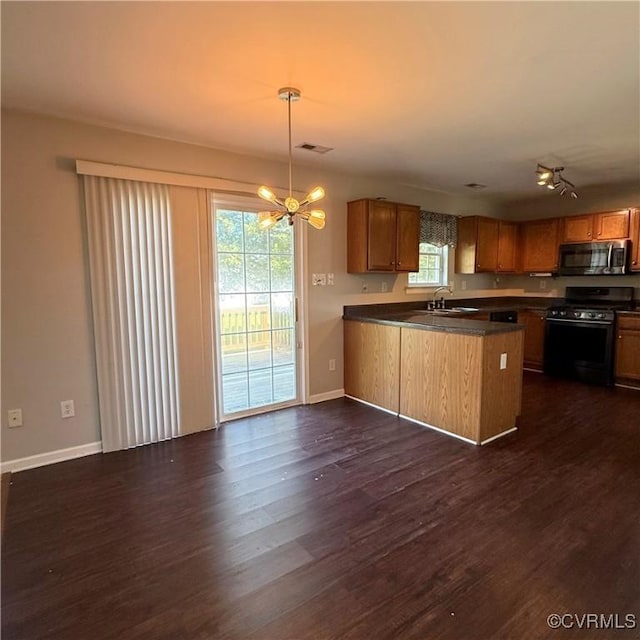 1353 Woodside Mews, Henrico, VA 23231 - kitchen featuring stainless steel microwave, a peninsula, dark wood-style floors, range with gas cooktop, and a sink
