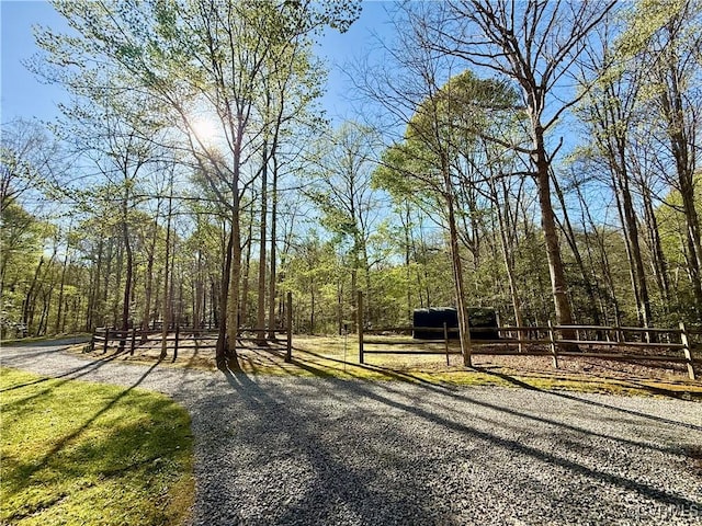 view of road featuring a wooded view