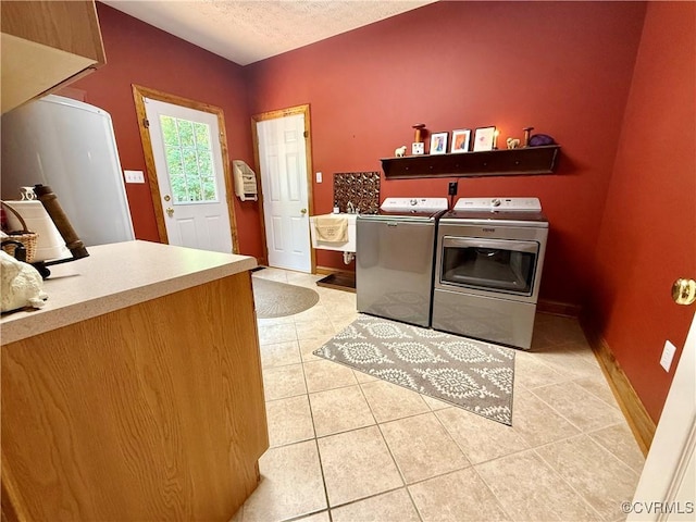 2222 Green Level Rd, King William, VA 23086 - washroom featuring separate washer and dryer, light tile patterned floors, and a textured ceiling