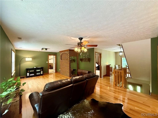 2222 Green Level Rd, King William, VA 23086 - living area featuring wood finished floors, a textured ceiling, and a ceiling fan