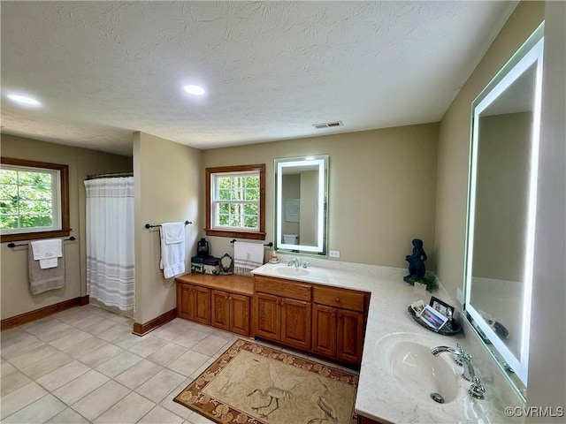 2222 Green Level Rd, King William, VA 23086 - full bath with plenty of natural light, vanity, a textured ceiling, tile patterned flooring, and recessed lighting