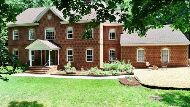 2222 Green Level Rd, King William, VA 23086 - back of house featuring a lawn, brick siding, and roof with shingles