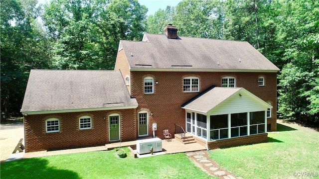 2222 Green Level Rd, King William, VA 23086 - rear view of house featuring a patio area, a sunroom, a chimney, a yard, and a shingled roof