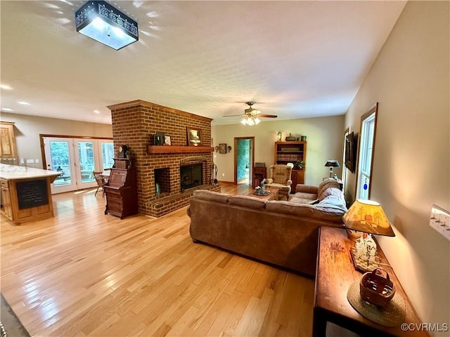 2222 Green Level Rd, King William, VA 23086 - living area featuring light wood finished floors, a brick fireplace, recessed lighting, and a ceiling fan