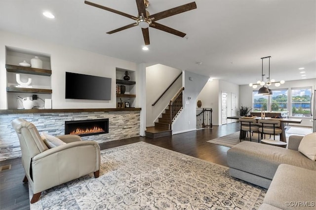 5007 Old Main St, Henrico, VA 23231 - living room with a warm lit fireplace, ceiling fan, stairs, wood finished floors, and built in shelves