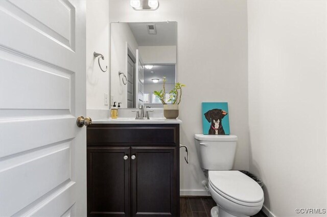 5007 Old Main St, Henrico, VA 23231 - bathroom featuring toilet, vanity, baseboards, and wood finished floors