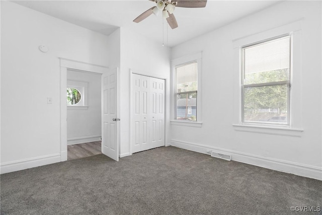 3153 Decatur St, Richmond, VA 23224 - unfurnished bedroom featuring baseboards, visible vents, multiple windows, and dark carpet