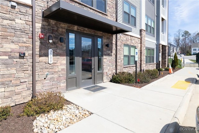 entrance to property with stone siding