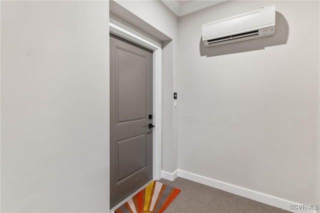 doorway with baseboards and a wall mounted AC