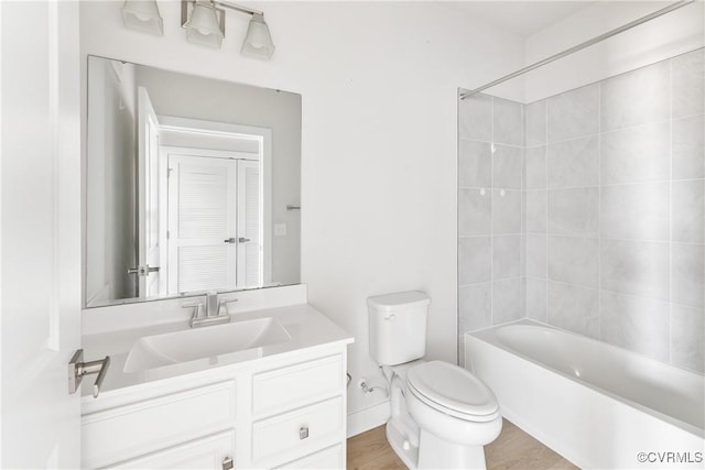 bathroom with toilet, vanity, and shower / bathing tub combination