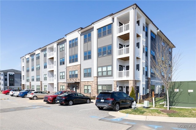 view of building exterior featuring uncovered parking