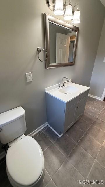 4409 Samara Dr, Henrico, VA 23231 - half bath featuring a notable chandelier, vanity, baseboards, tile patterned flooring, and toilet
