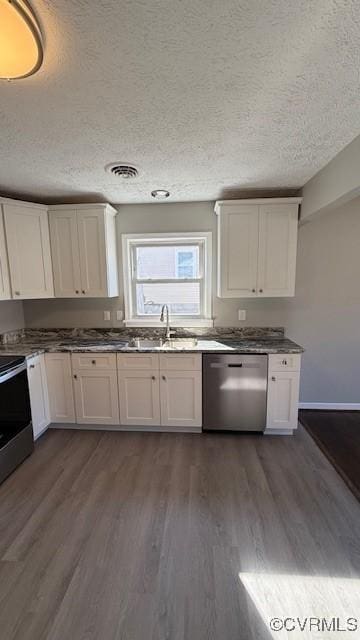 4409 Samara Dr, Henrico, VA 23231 - kitchen featuring a textured ceiling, white cabinets, appliances with stainless steel finishes, a sink, and dark wood-style floors